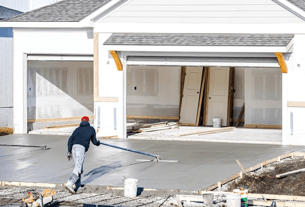 Concrete worker smoothing a fresh concrete pour in Brantford